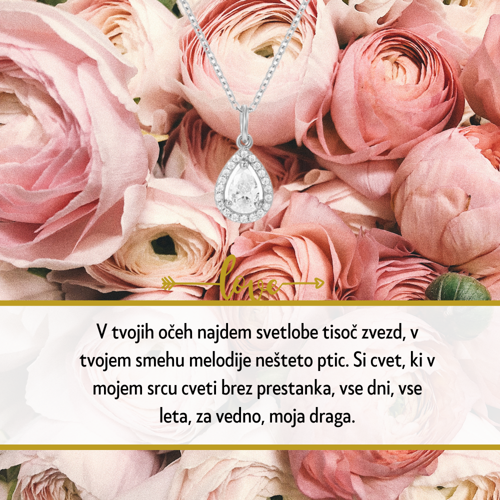 Personalizirana srebrna verižica z vgraviranim imenom in datumom, obdana z majhnimi kristali, kot idealno darilo za Dan žena. Elegantna darilna škatla na beli podlagi z rdečo vrtnico ob strani, simbolizira ljubezen in spoštovanje na poseben dan